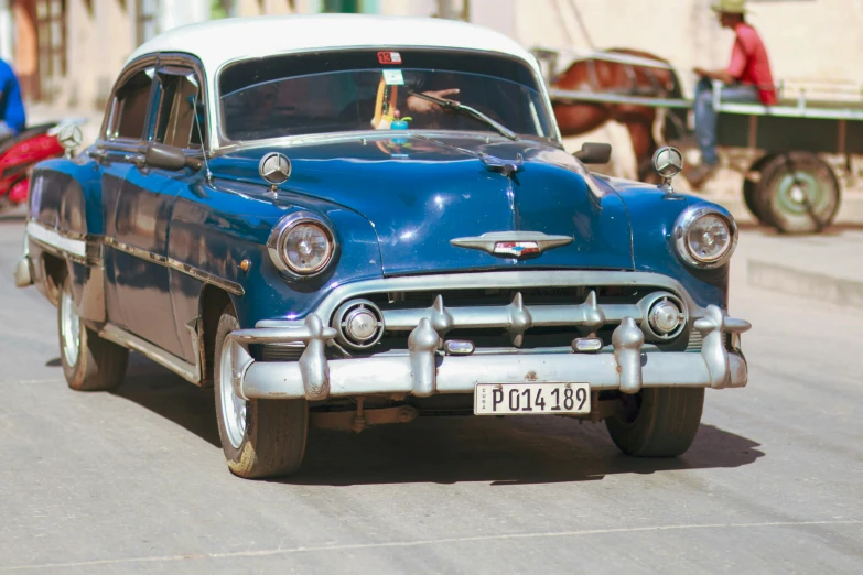 a blue car is parked on the street