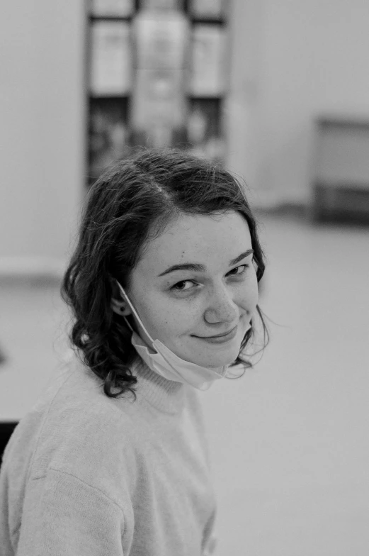 a woman sitting in front of a table talking on her cellphone