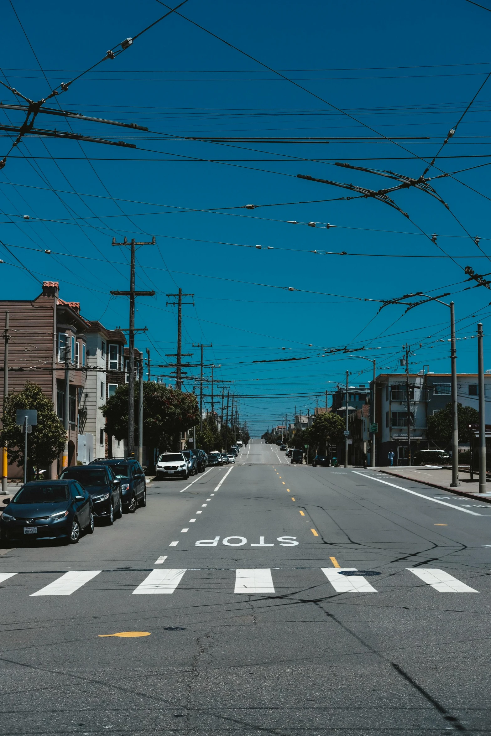 a empty street with power lines above it