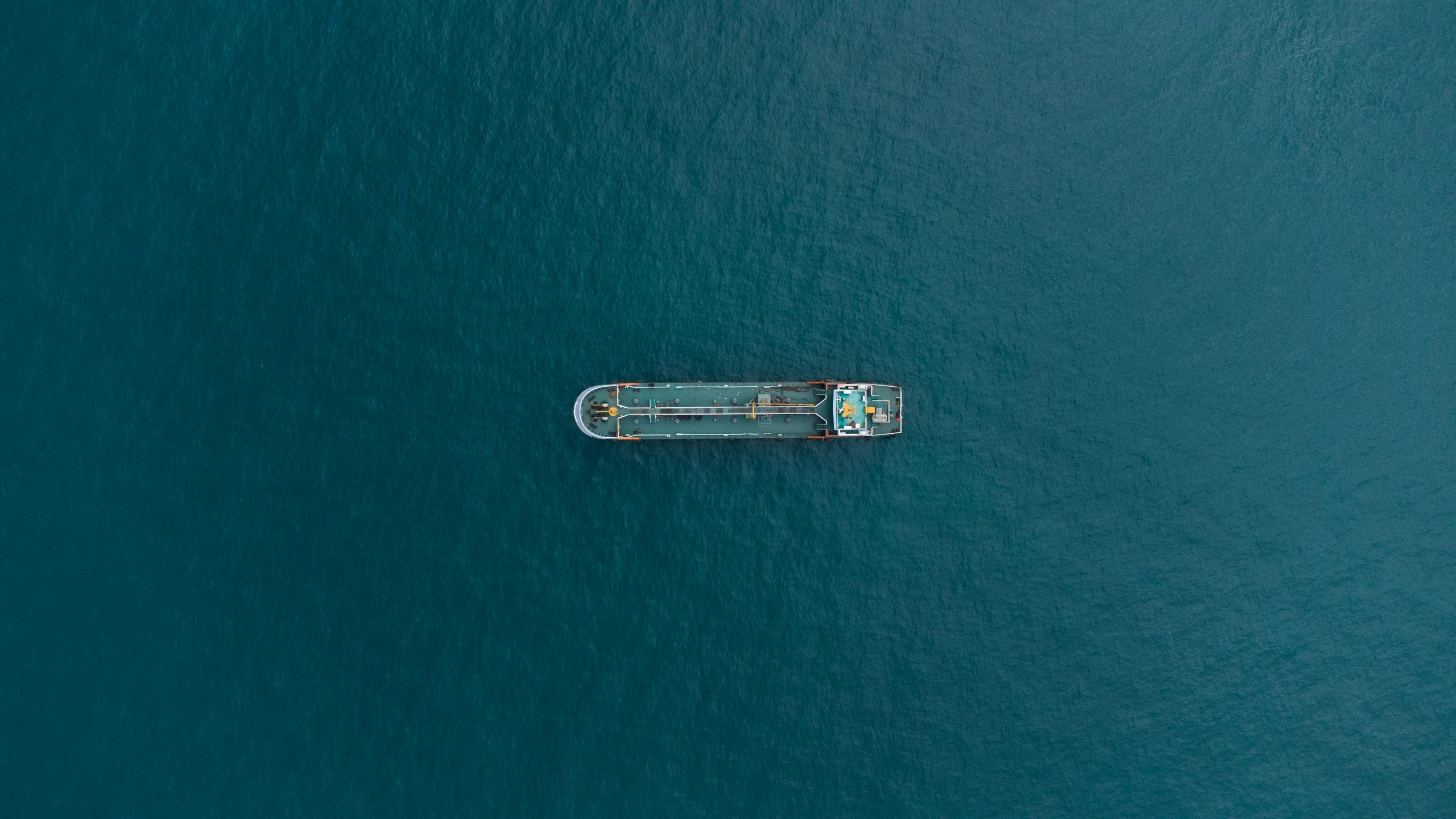 a long boat in the ocean during the day