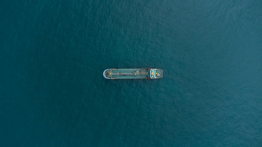 a long boat in the ocean during the day