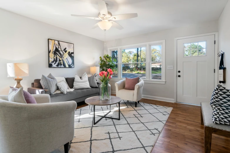 the room is clean and organized with a couch and chair