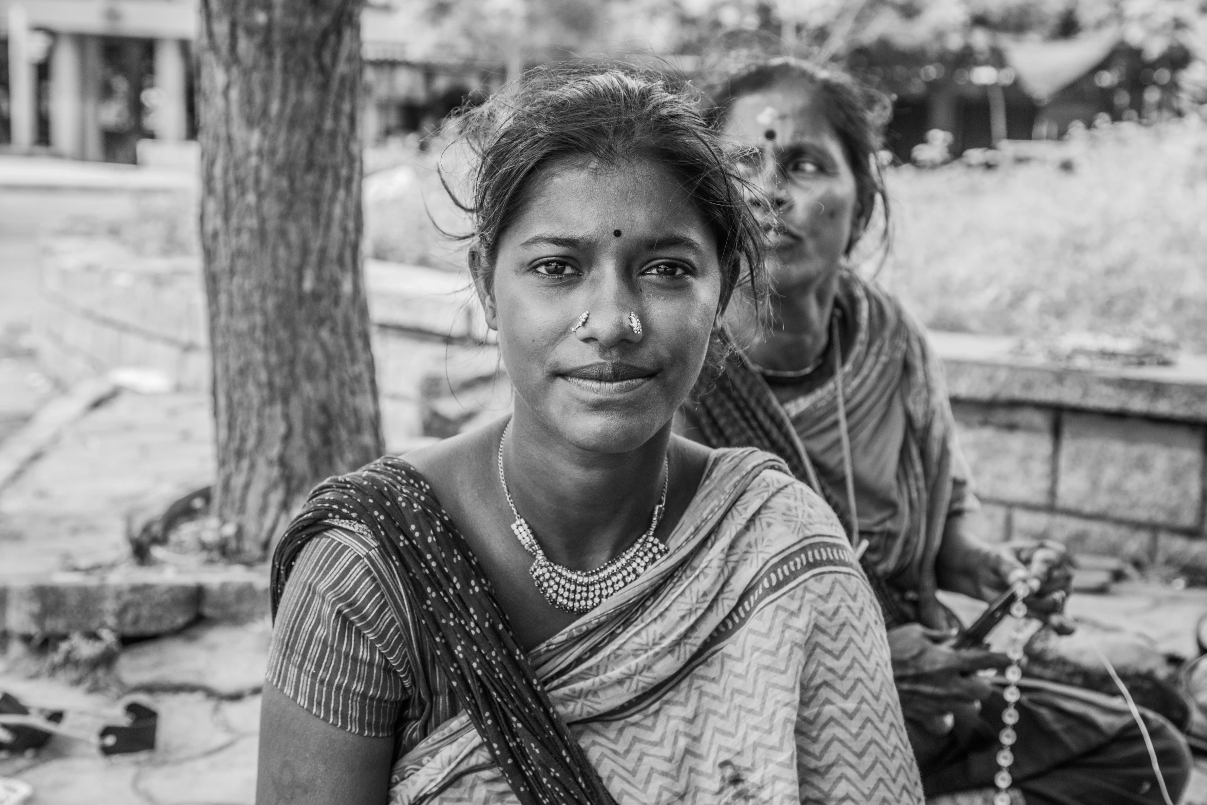 an indian lady posing in front of her friend