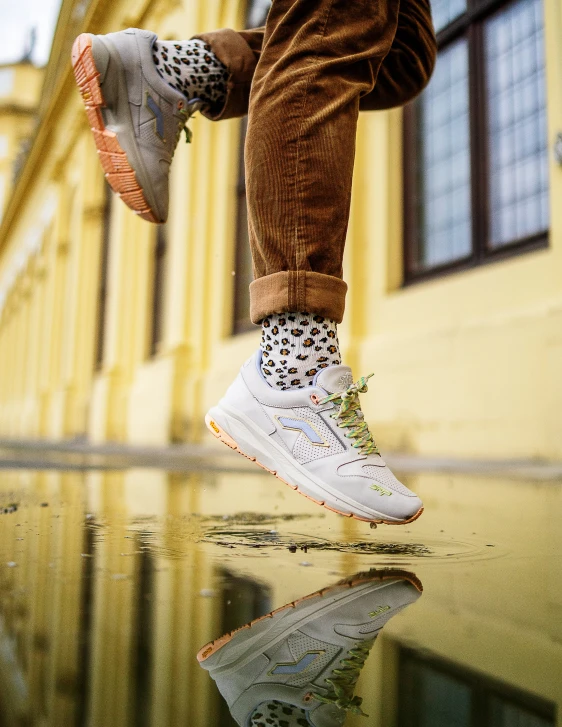 person in orange pants jumping on skateboard