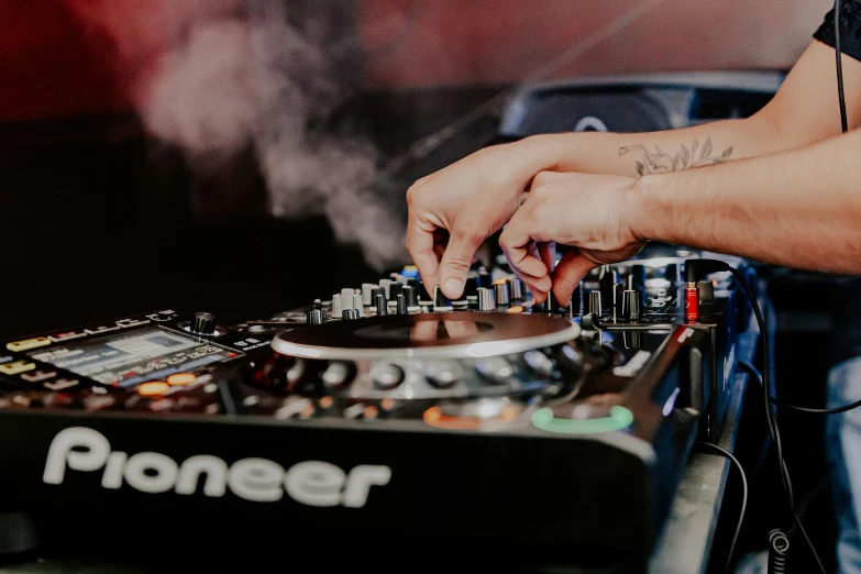 the dj uses his equipment for music