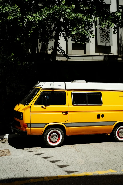 a van sitting in front of some green trees