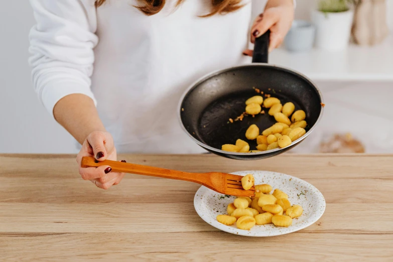 someone is cooking food in a wok