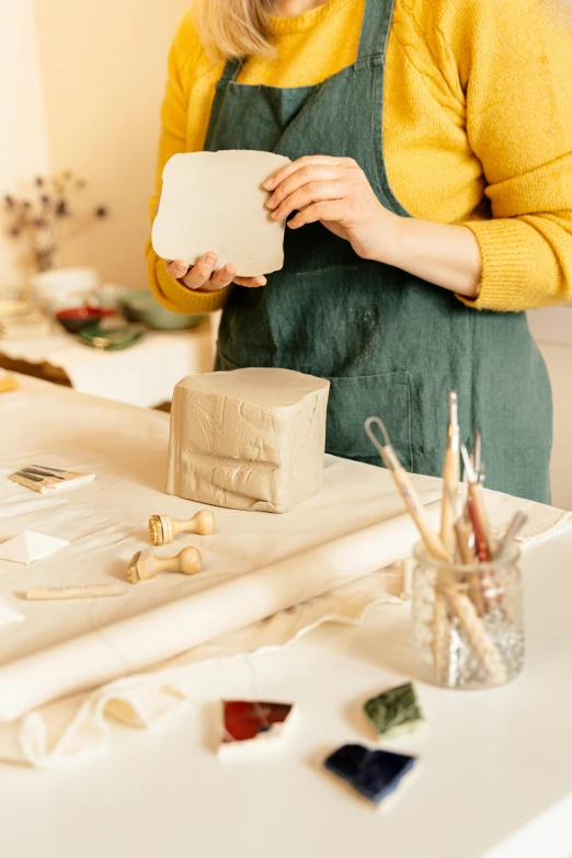 woman is working on crafting with a wooden block