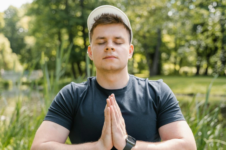 a man in black shirt and hat with a blue shirt