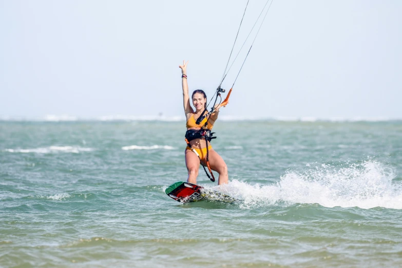 a woman is para sailing in the water