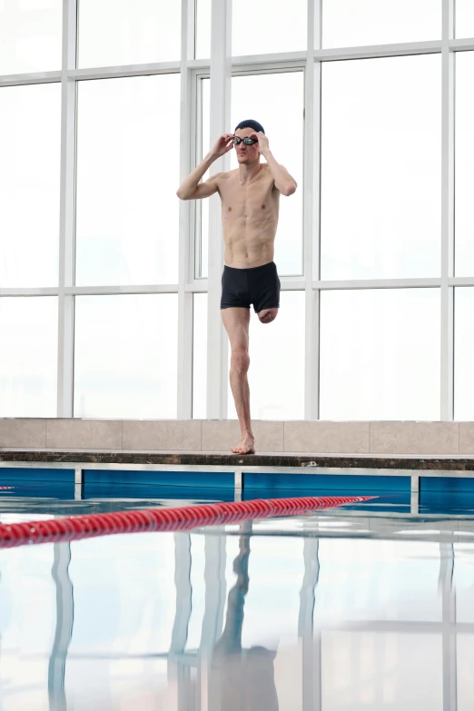 a man with  and no pants standing on a red raft