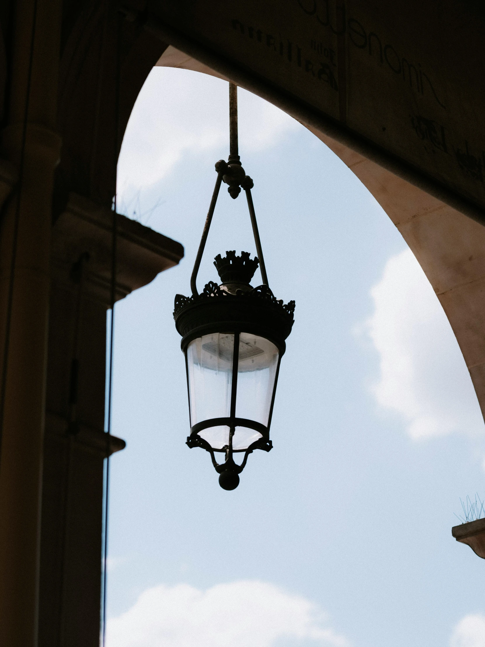 there is a street lamp that appears to be hanging from an arch