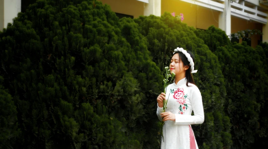 the girl is posing holding a vase in her hand