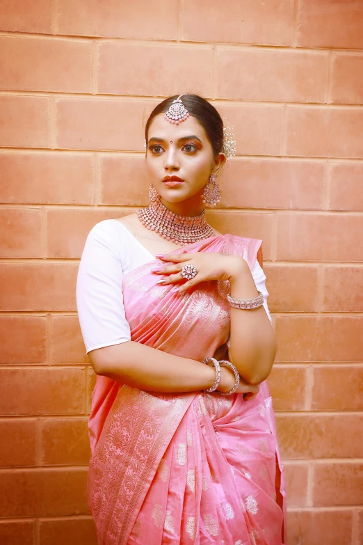 a beautiful woman in a pink dress posing for a picture