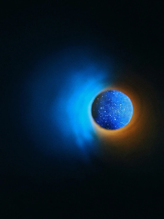 a bright blue object in the dark
