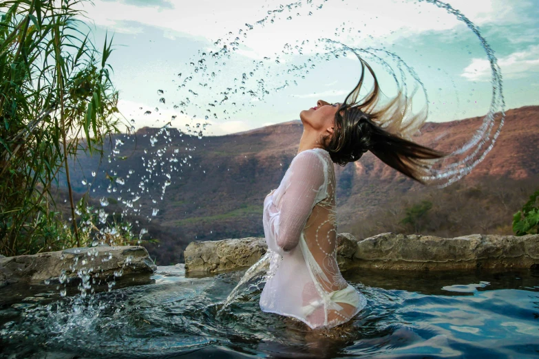 a woman in the water playing with water