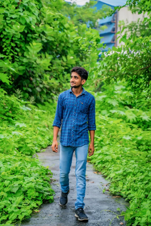 a man walking through a lush green forest