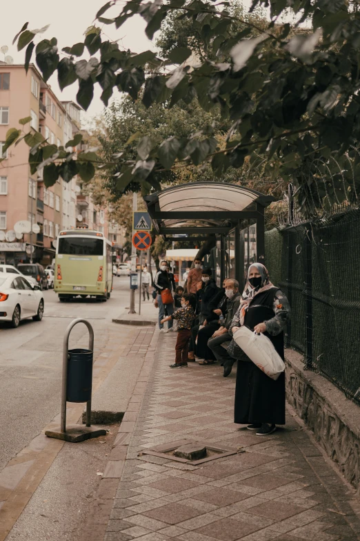 many people are on the sidewalk with no shoes