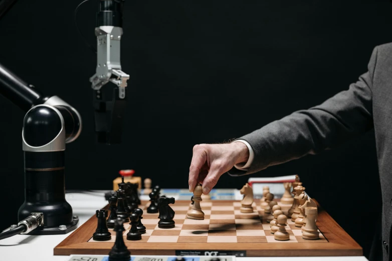 a man is playing chess in front of a microphone