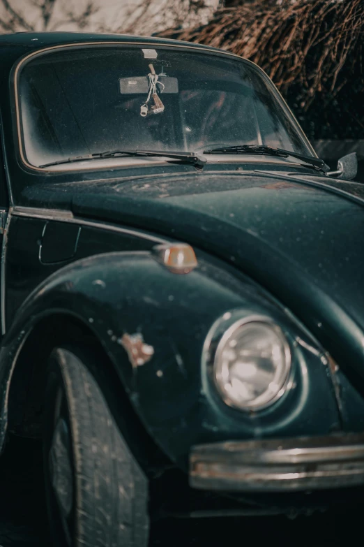 an old vw beetle parked on the side of the road