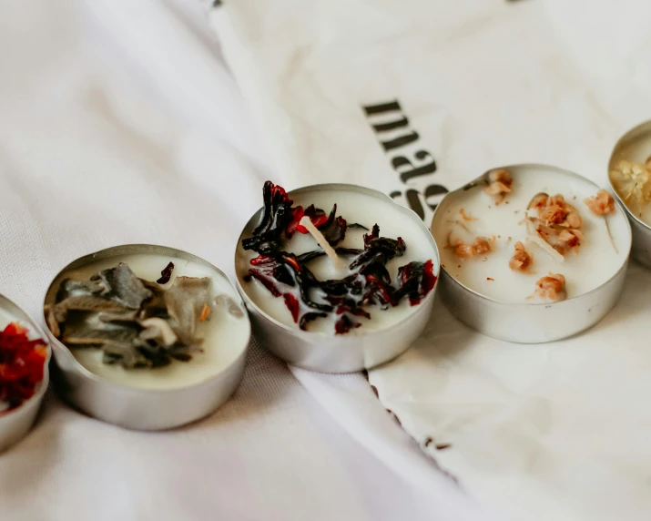 four tins of various small things on a table