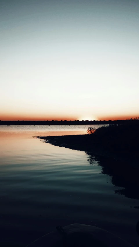 an empty boat with the sky reflected in the water