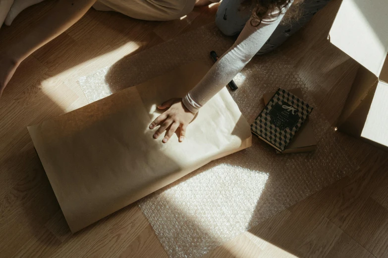 a woman laying on a mat while using a heat dryer