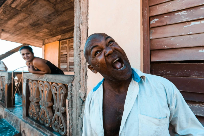 an old man laughing next to a woman