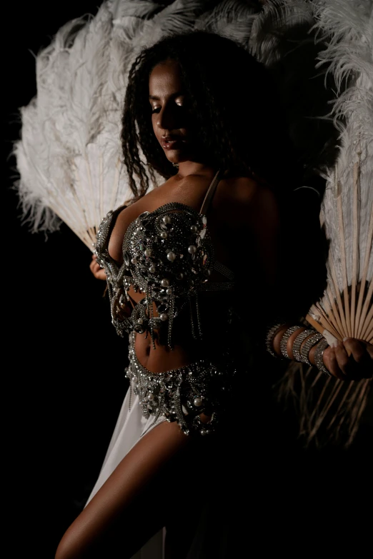 a beautiful woman dressed in a  dress and feathers