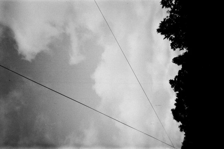 a power line stretches into the distance with trees to far distance