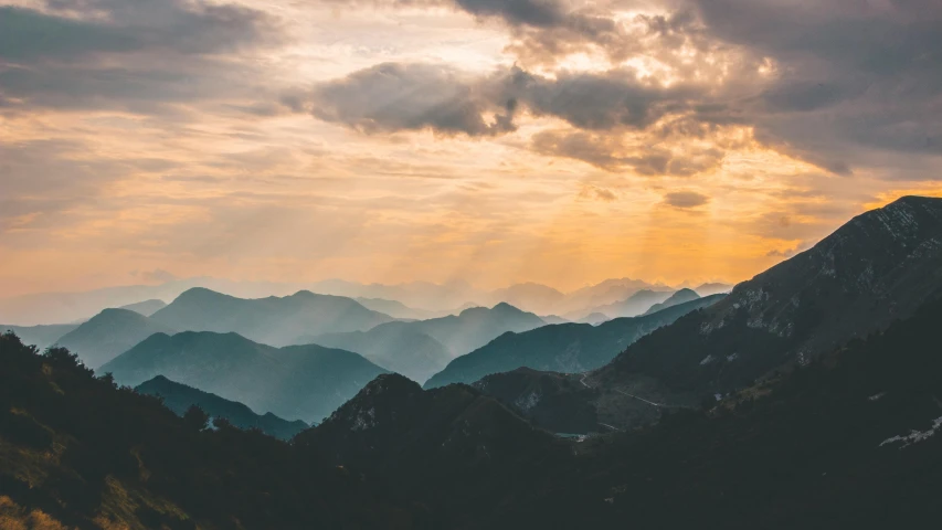 mountains with trees and clouds in the evening