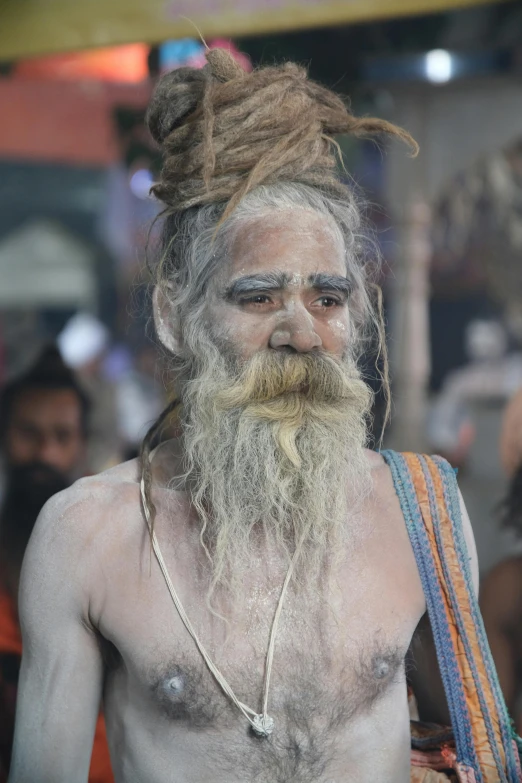 a man with dreadlocks with a fake beard on