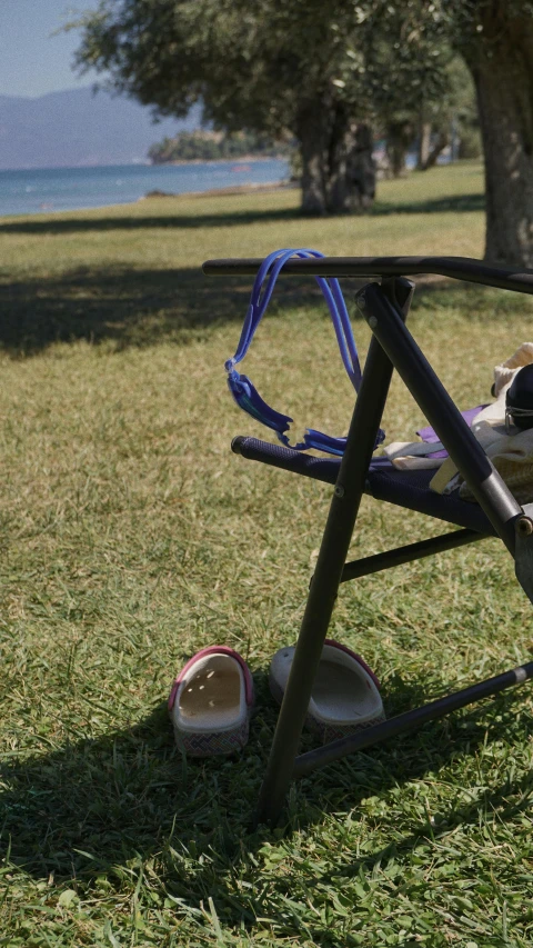 a baby girl's high chair with a pair of shoes under it