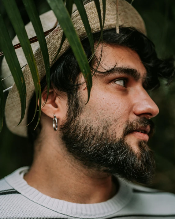 a man with a long beard wearing a hat