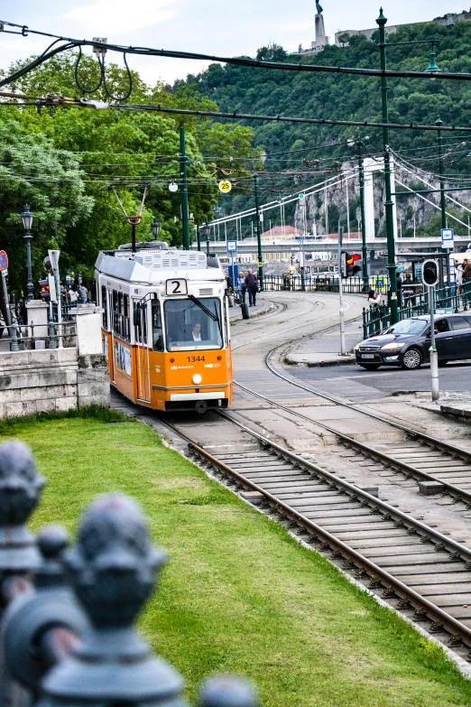 a small trolly train traveling down a busy road