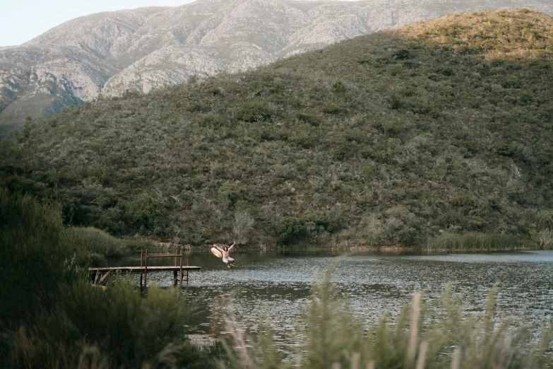 a person jumping off the water into the ocean