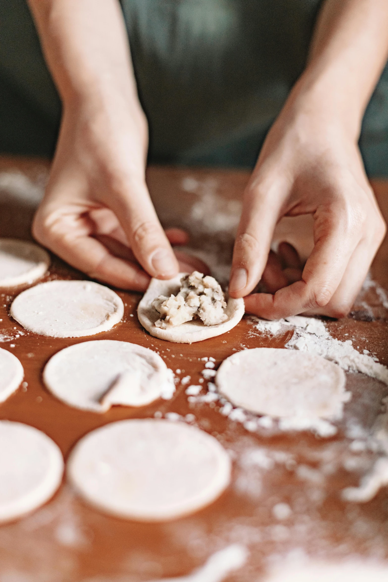 a woman putting some food in to some batter