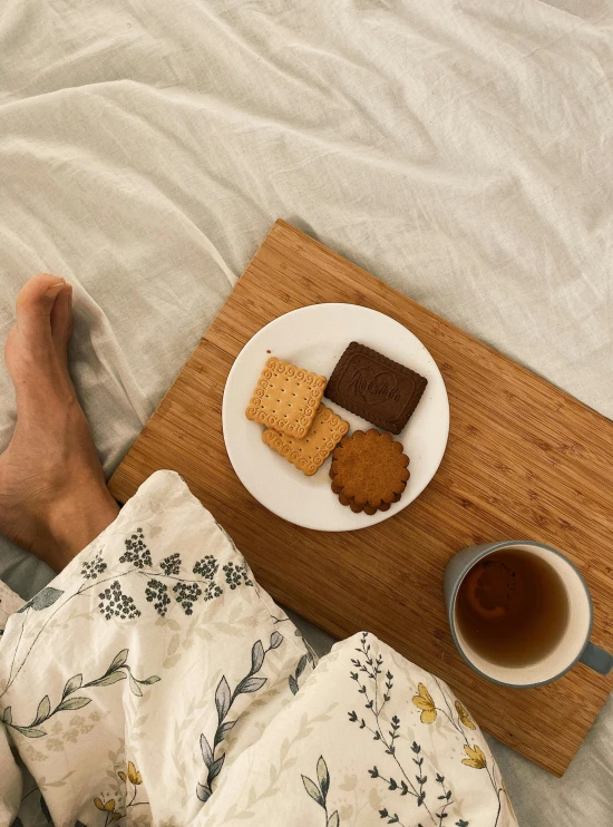 a person holding their feet over some food