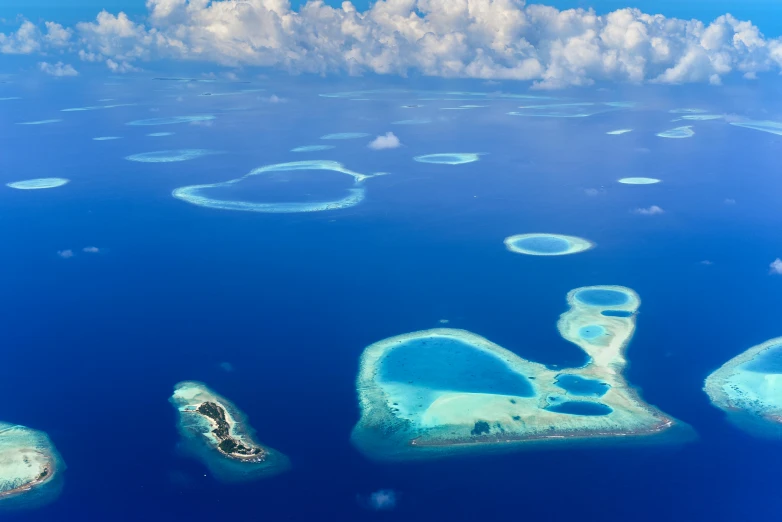 an island with several small blue islands in the ocean