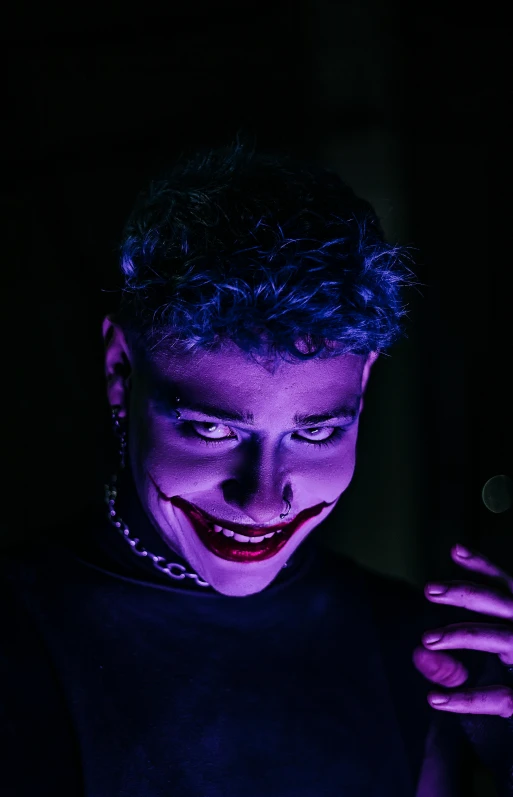 a man with evil face on his face looking at a cell phone