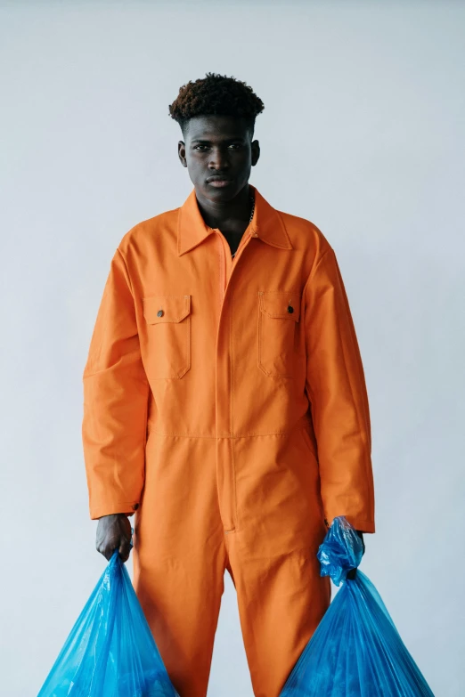 an african american man wearing orange prison uniform