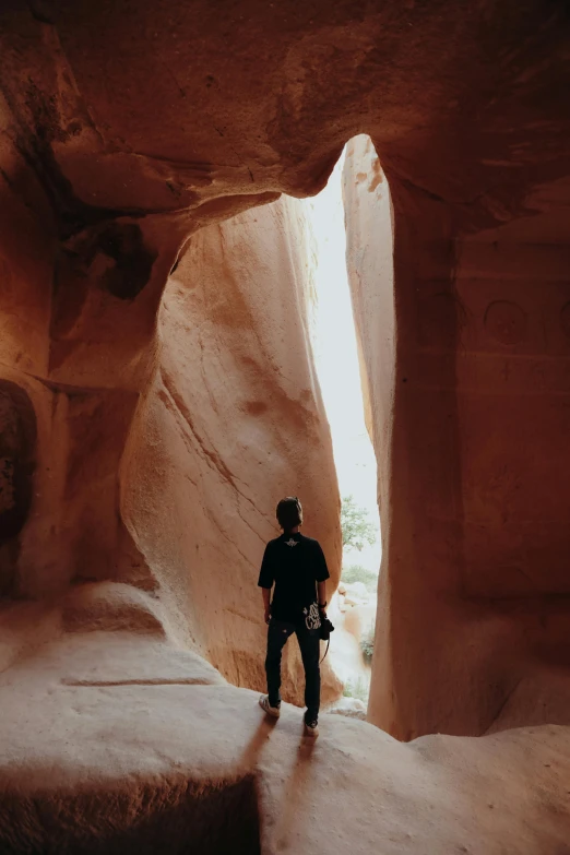 a man standing in the end of a canyon