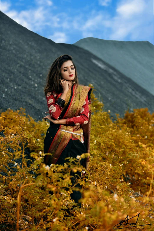 a woman standing on top of a field holding onto her hand