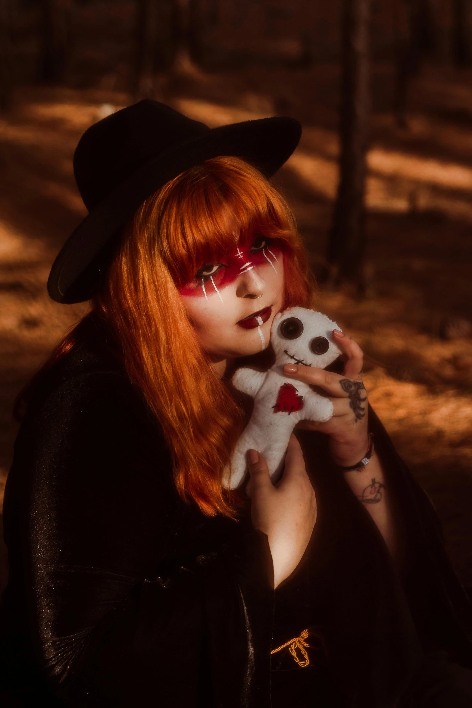 a woman holding a small white stuffed animal