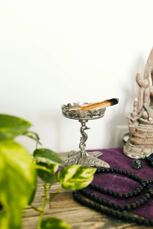 a small silver candlestick on a wooden table