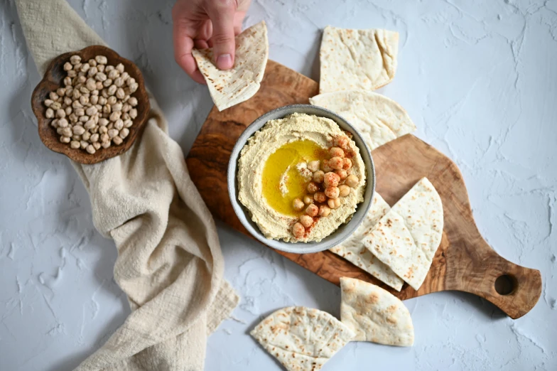 hummus and beans served in a bowl with pita bread