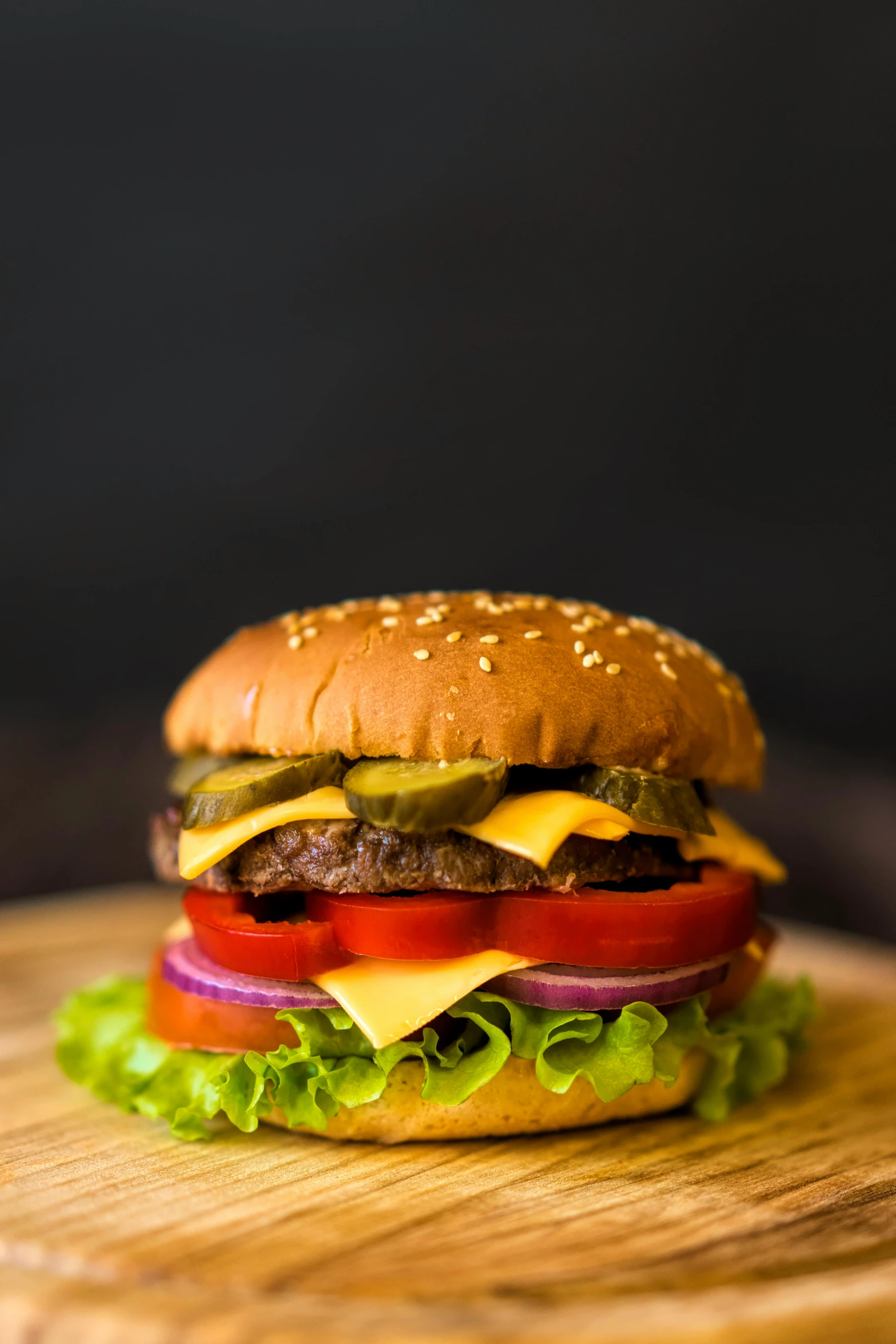 a hamburger sitting on top of a wooden  board