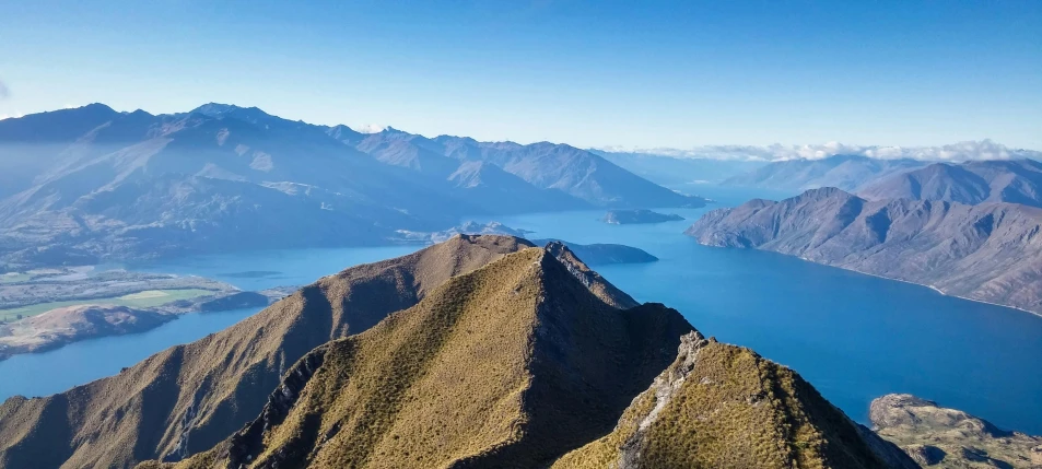 mountains and lakes are seen in the distance from an aircraft