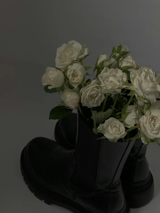 there is white flowers inside of a boot