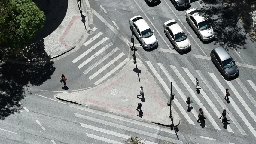 an aerial view of cars and motorcycles on a city street